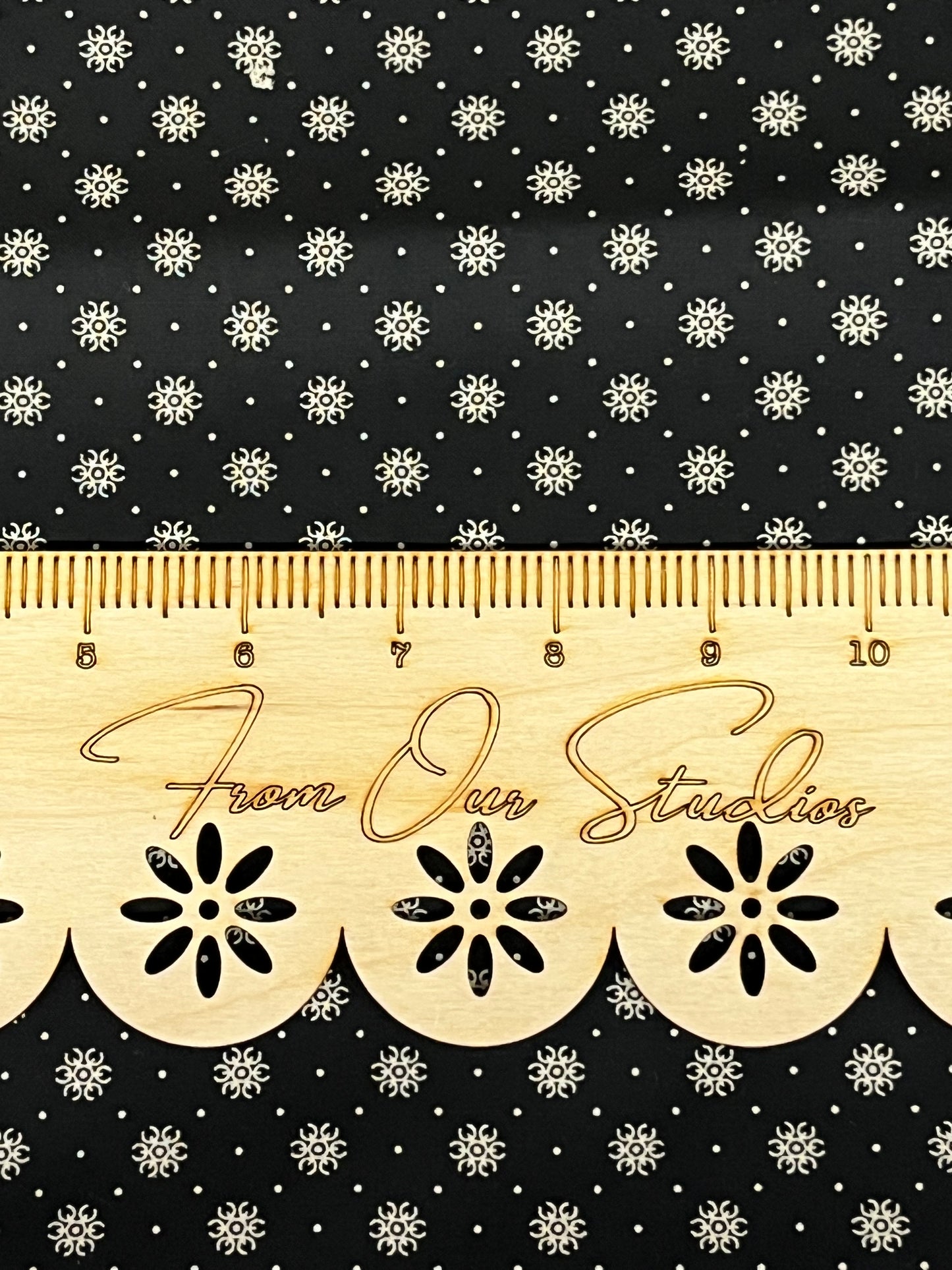 Small-scale black and cream floral starburst cotton fabric, quilting weight, sold in fat quarters by Marshall Dry Goods.