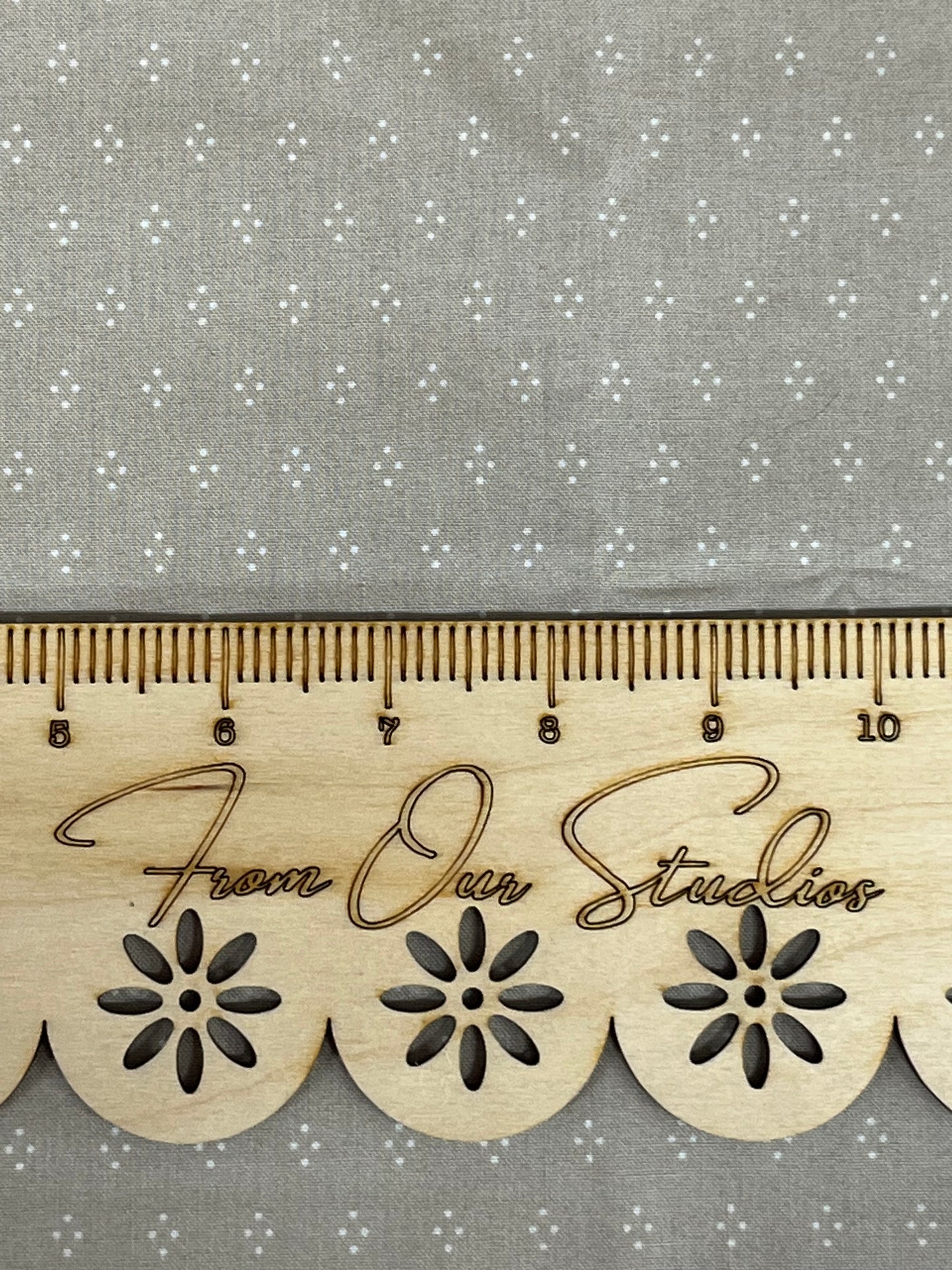greige fabric with small white polka dots arranged in a diamond pattern great for quilt making slow stitching and junk journals