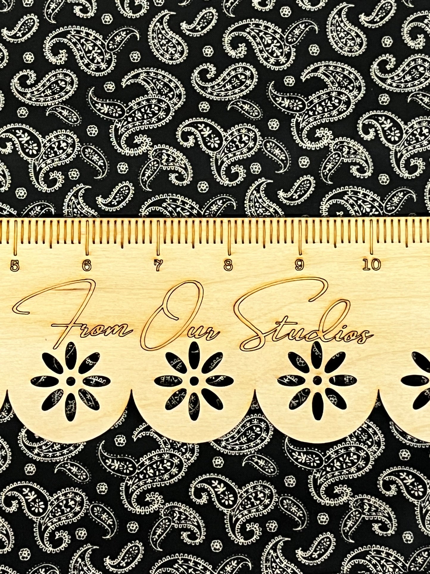 Primitive vintage reproduction fabric by Marshall Dry Goods, fat quarter cut of black cotton with cream paisley design.