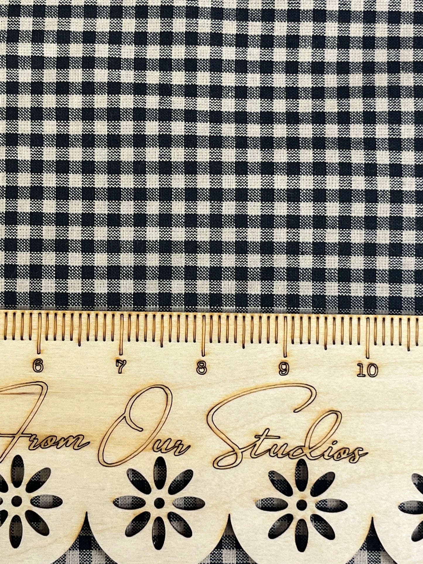 Black and tan small check homespun fabric cut into fat quarters for sewing, quilting, and country craft projects.