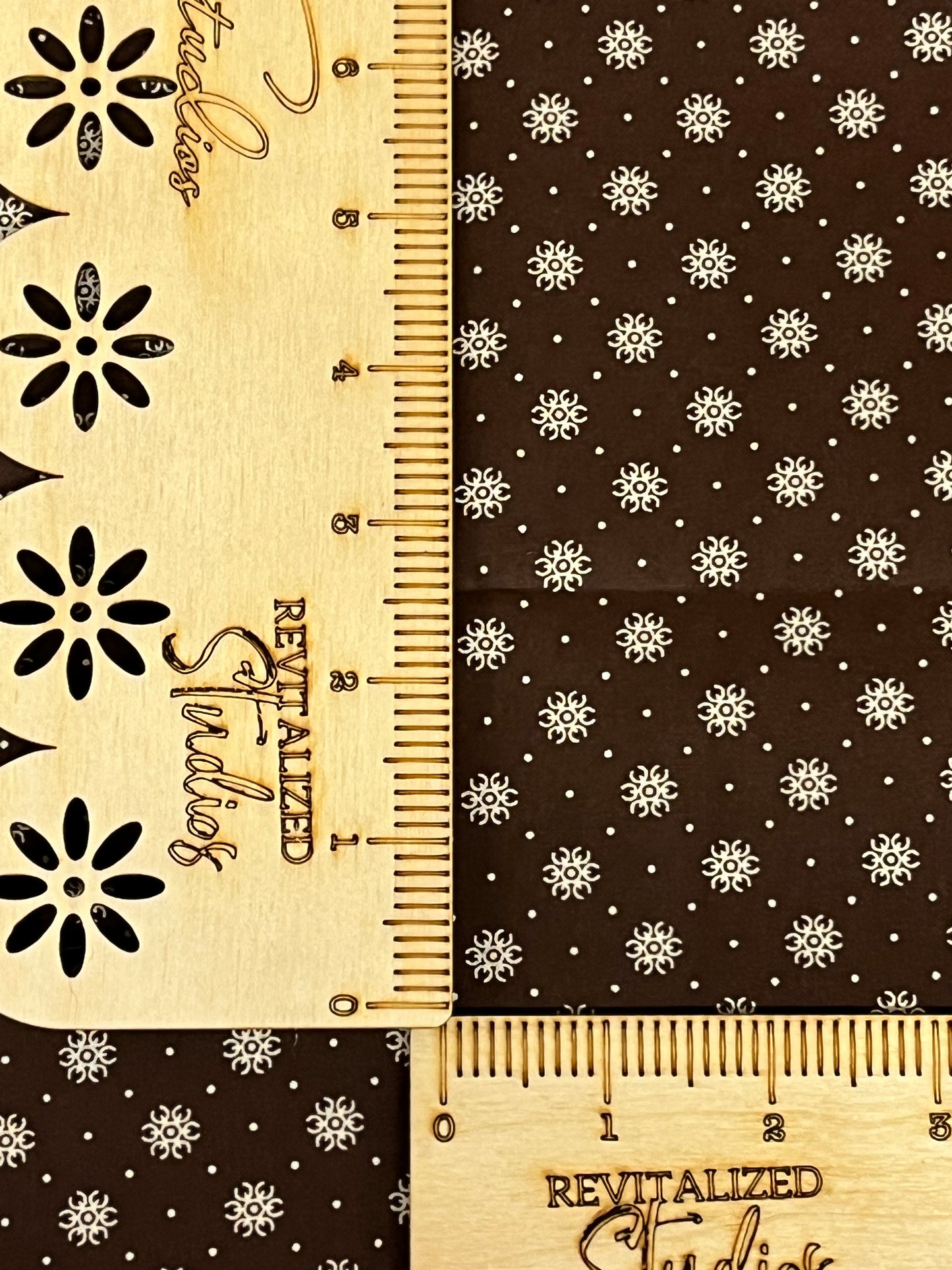 hocolate brown reproduction cotton fabric with cream snowflake star print, sold in fat quarters by Marshall Dry Goods.