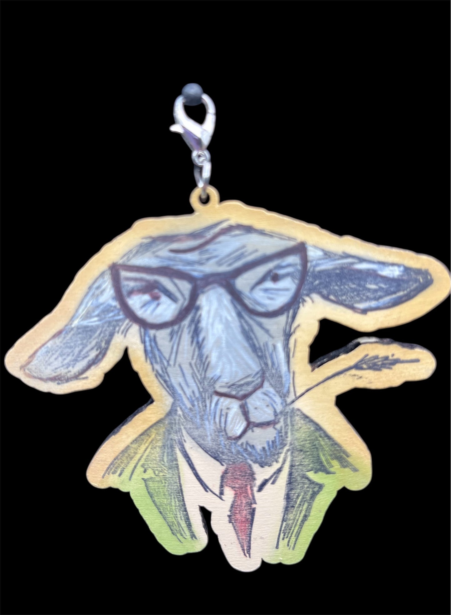 Hand-painted wooden goat charm wearing glasses, green jacket, and red tie with lobster clasp