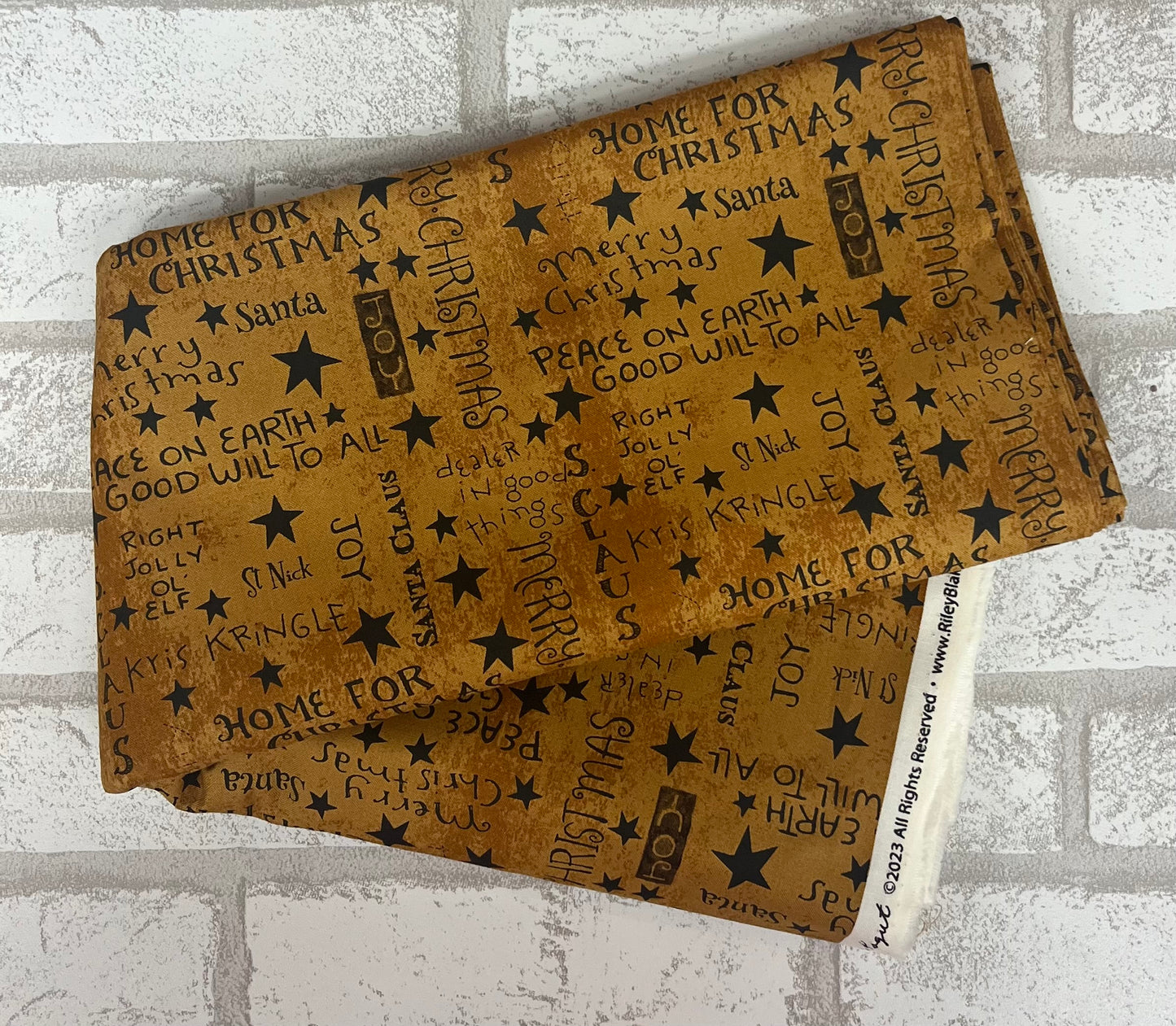 Mustard fat quarter with black Christmas phrases Riley Blake fabric
