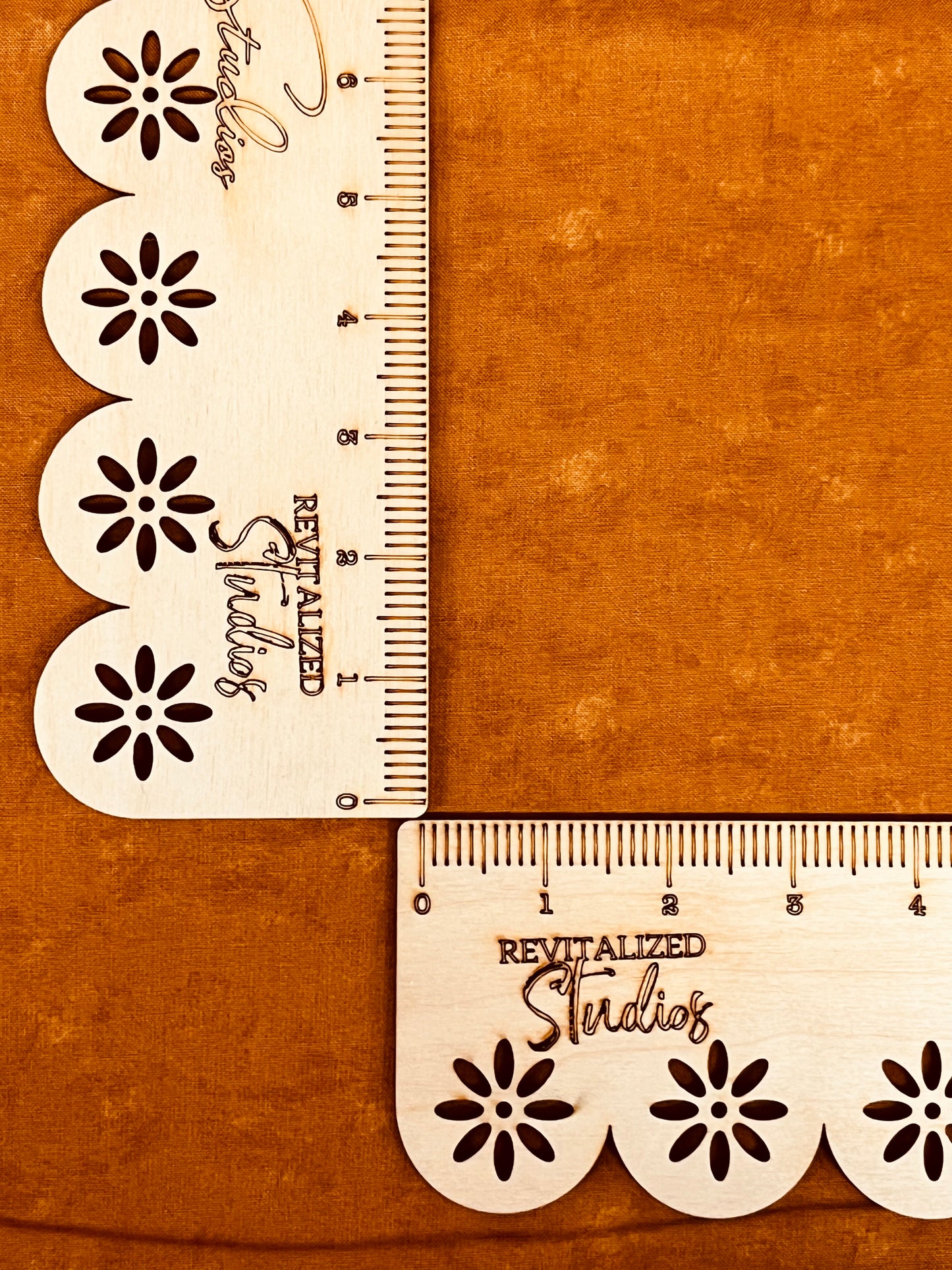 A fat quarter piece of orange tonal fabric with a floral pattern design, labeled as revitalized studio fabric.