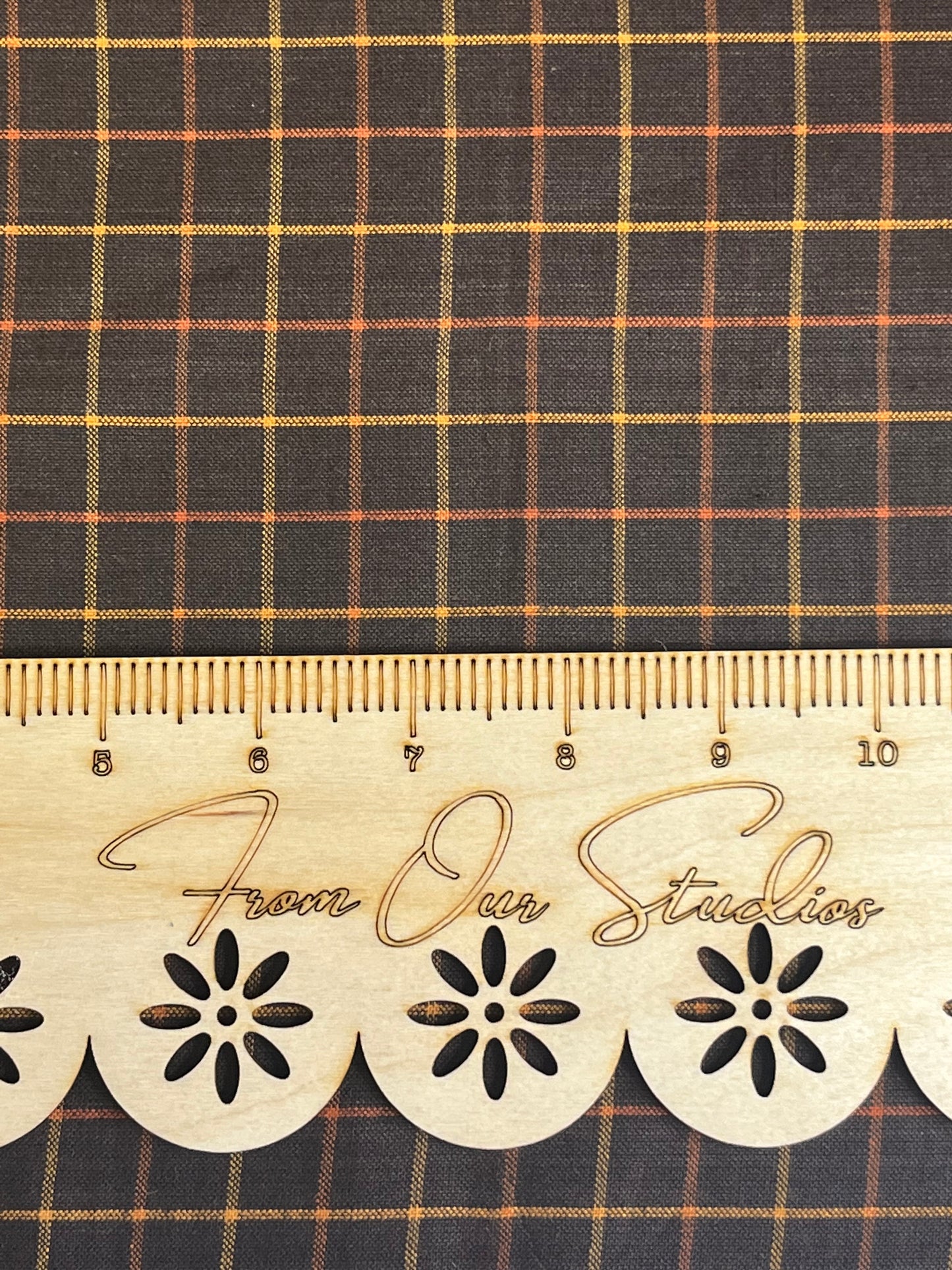 Medium-scale black plaid cotton fabric with rust and gold check pattern, 18x22 inch fat quarter by Andover Fabrics.