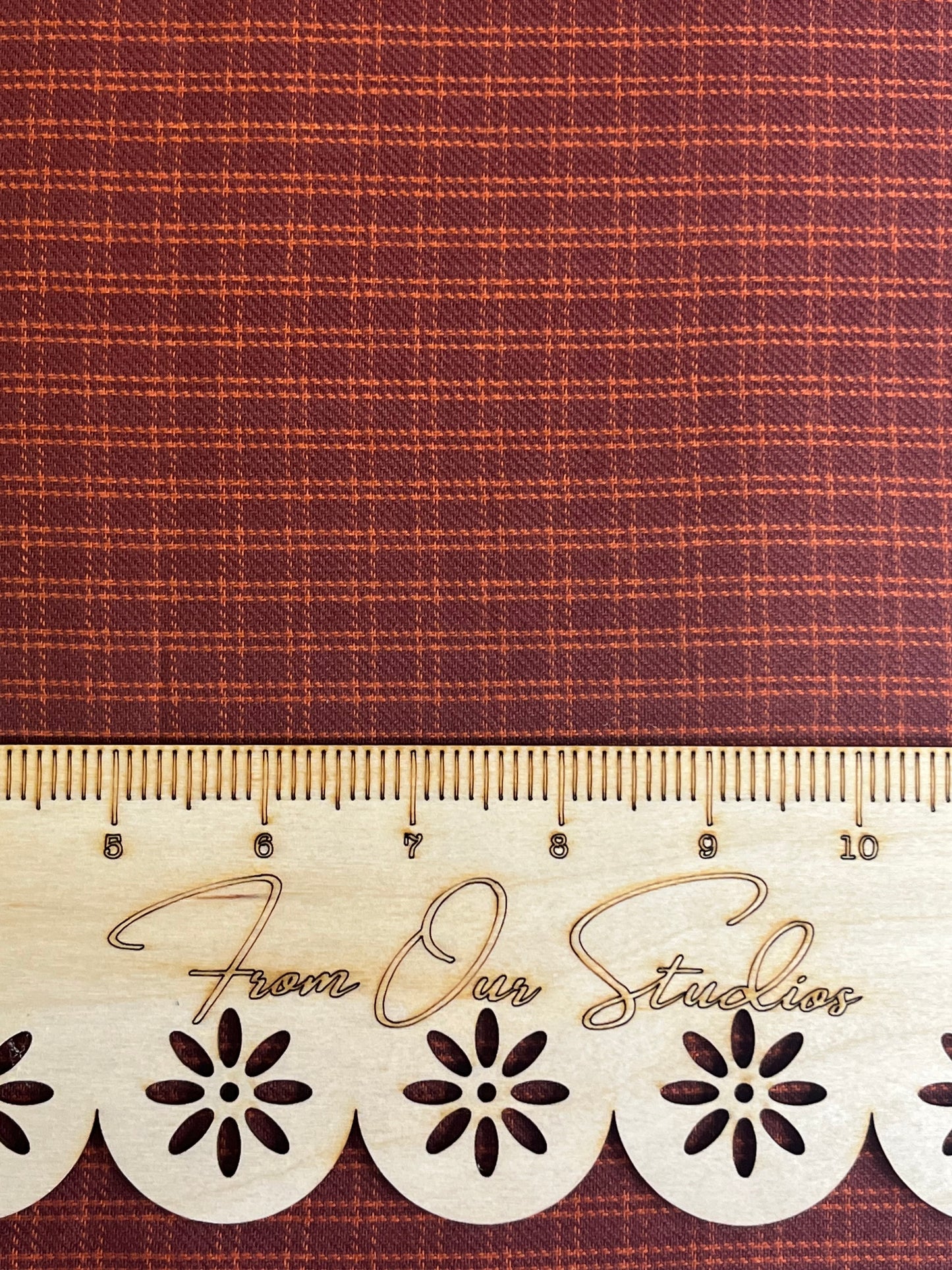 Detailed view of Andover Fabrics brick red on orange small check fabric. Rustic cotton fat quarter for quilting, primitive sewing, and handmade doll making.