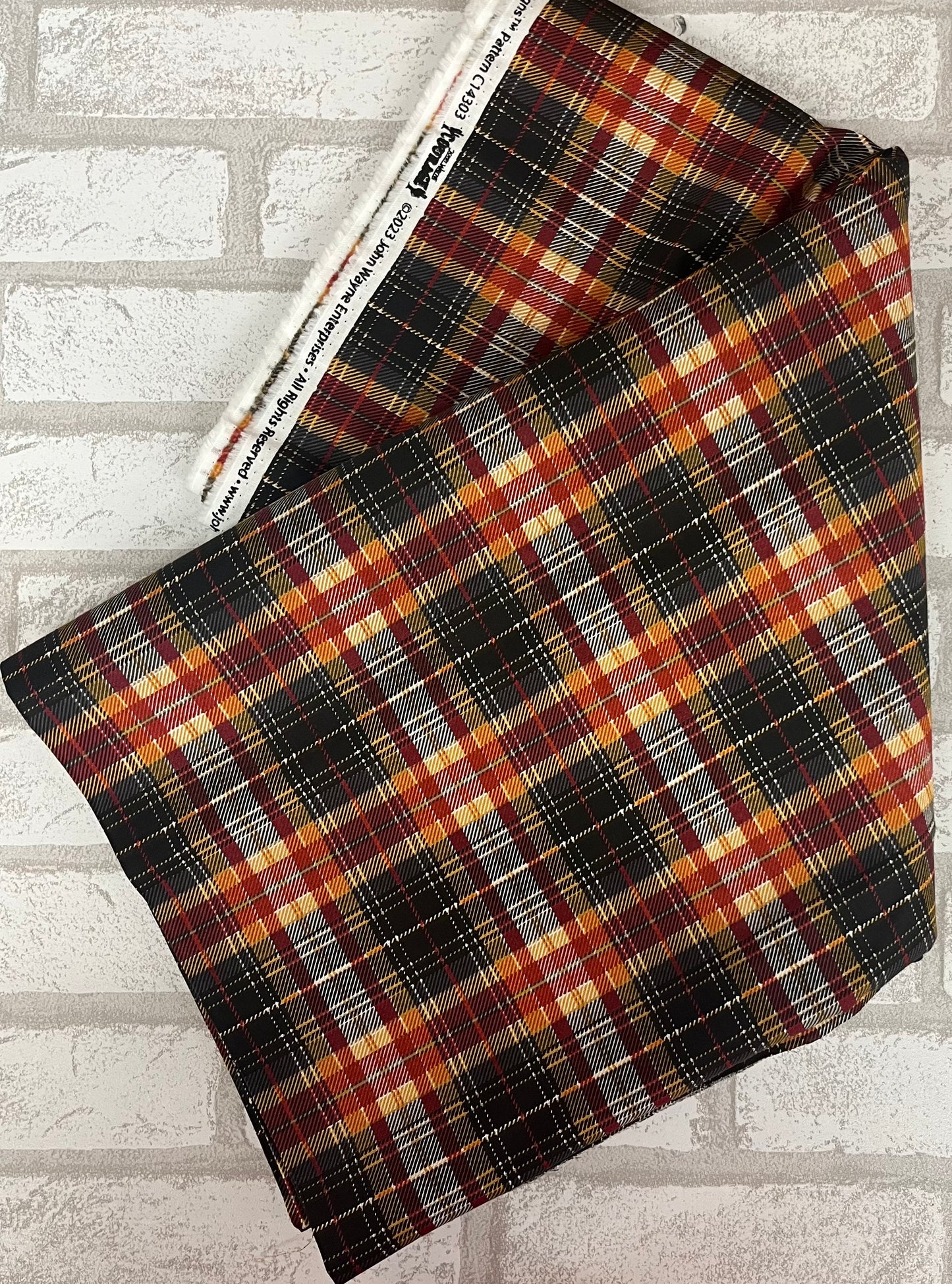 Black, orange, cream, deep red plaid fat quarter for Riley Blake part of the John Wayne Courage collection.