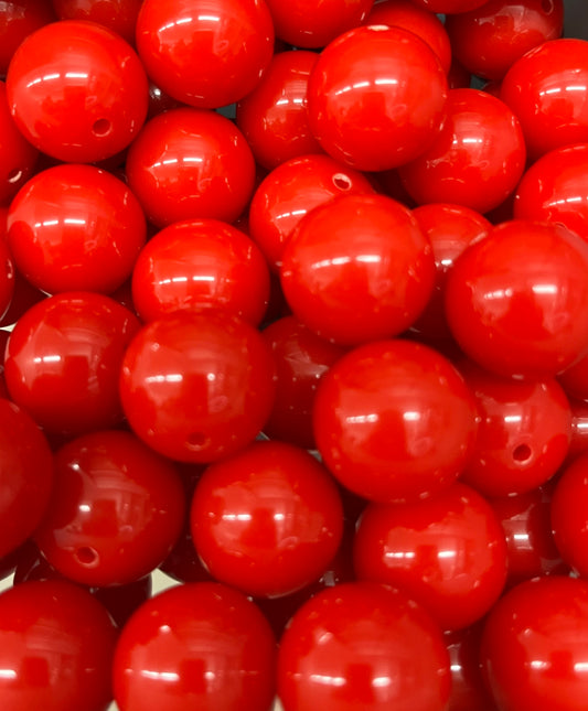 Close-up of glossy 20mm bright red bubblegum beads, perfect for jewelry making or junk journal crafts