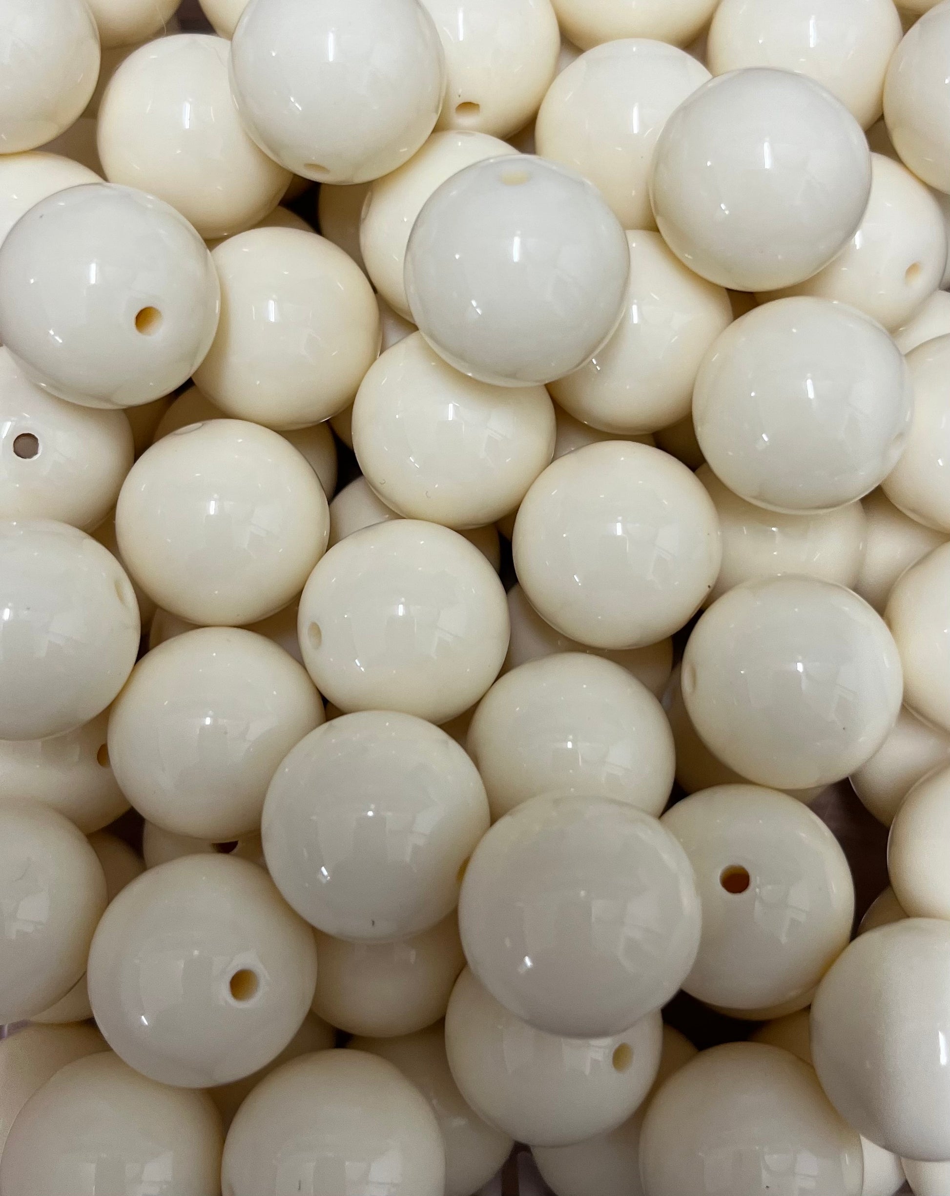 Close-up of 20mm cream glossy round bubblegum beads for jewelry and crafts