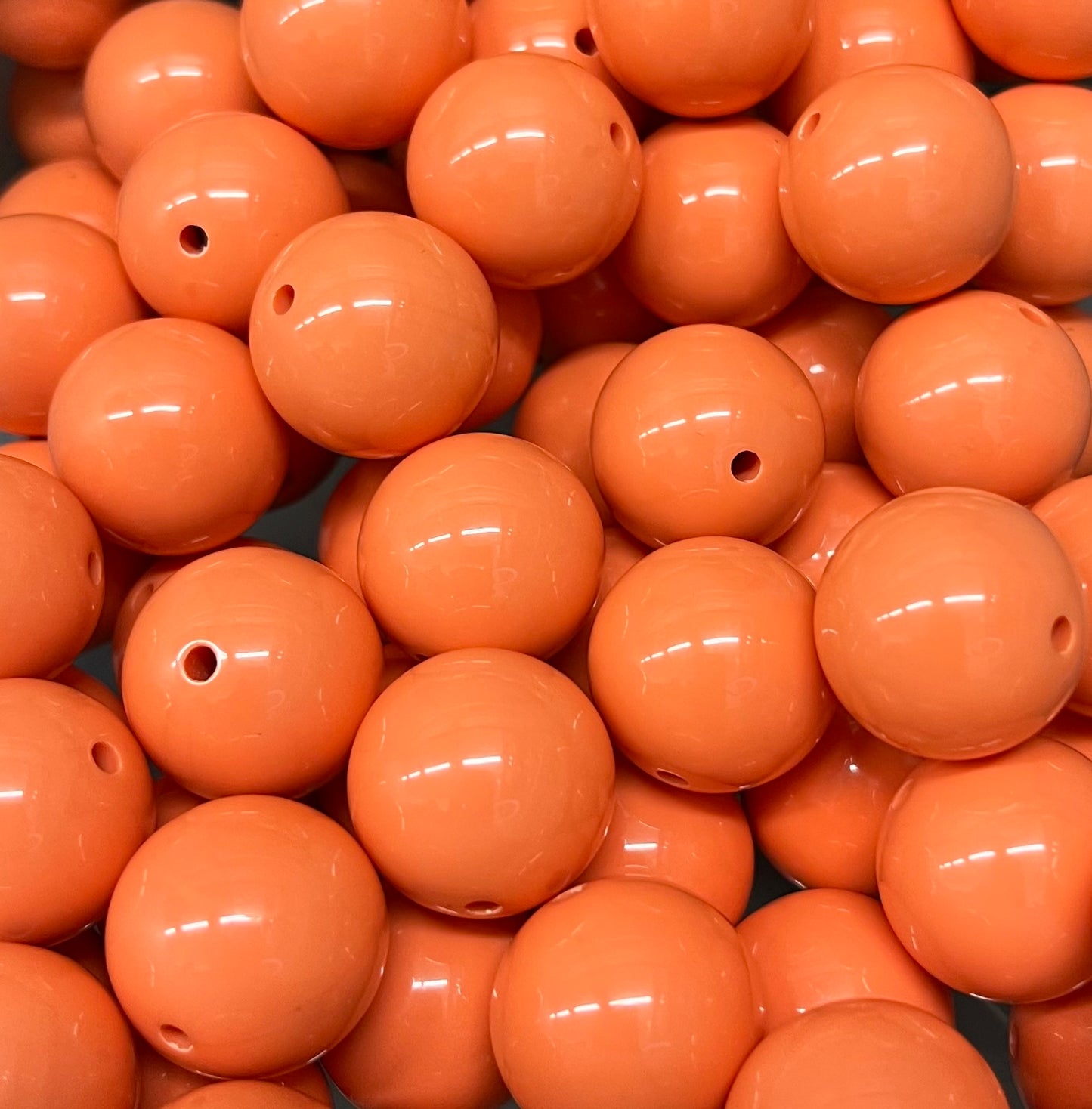 Close-up of glossy 20mm peach bubblegum beads in soft peach color – Revitalized Studios B1017