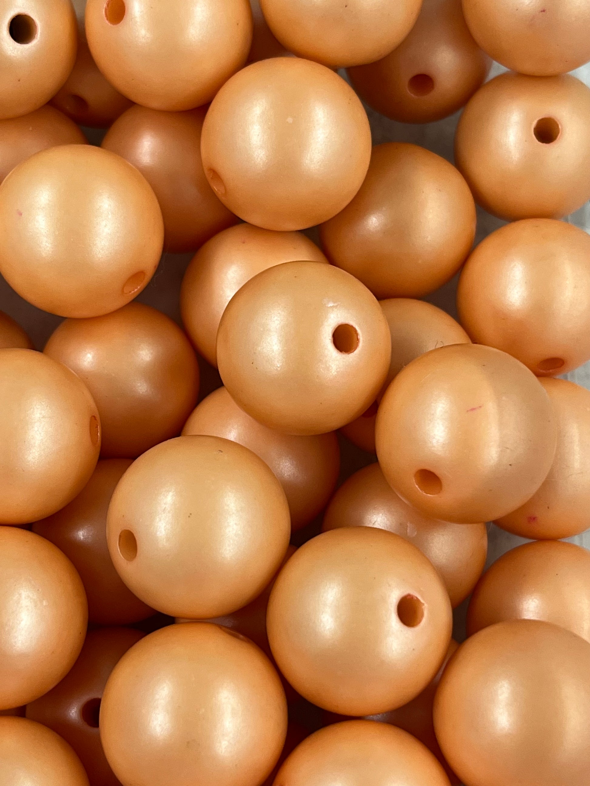 Close-up of 20mm Peach Pearl Bubblegum Beads with soft shimmer finish