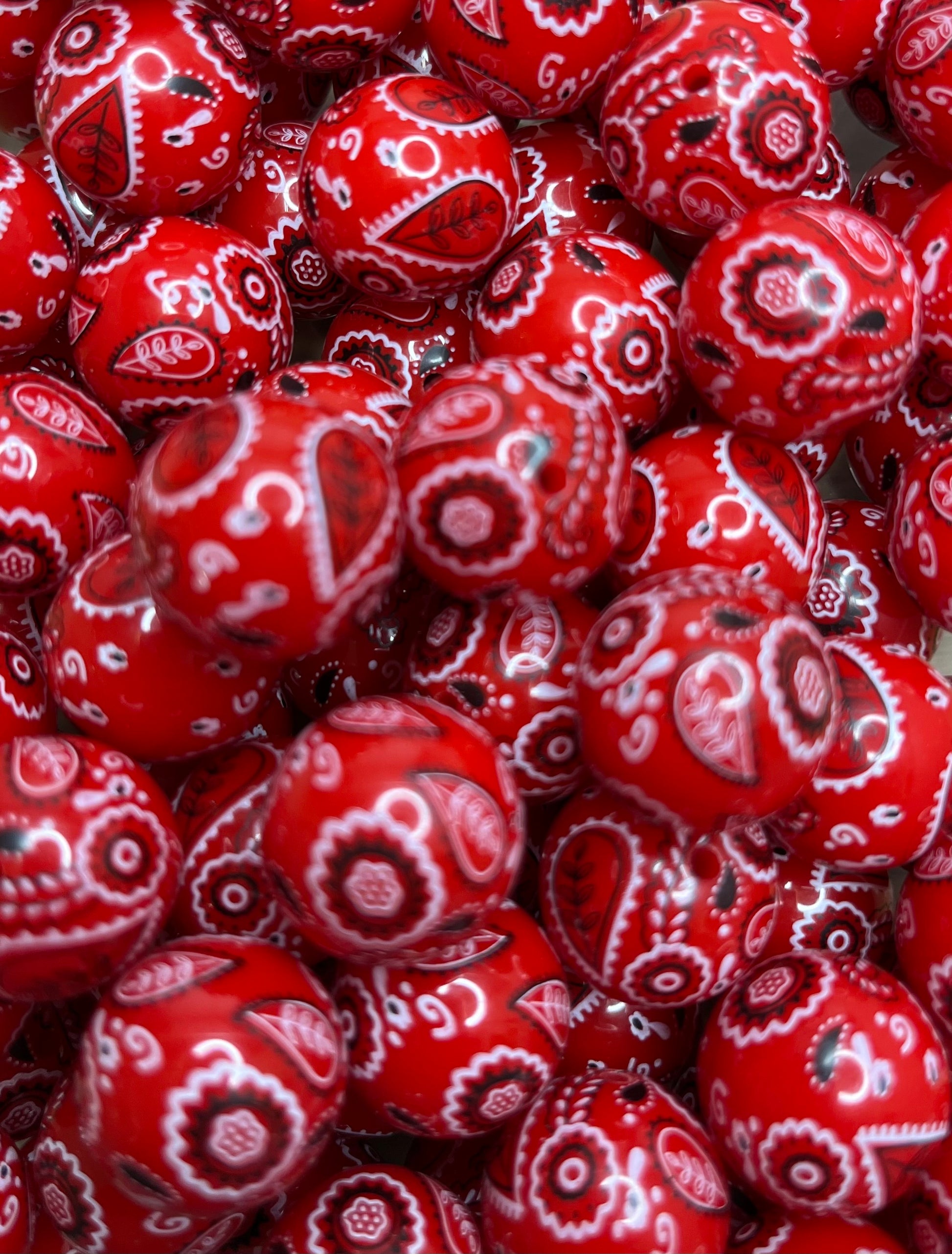 Close-up of red handkerchief bandana print 20mm bubblegum beads for western and farmhouse craft projects.