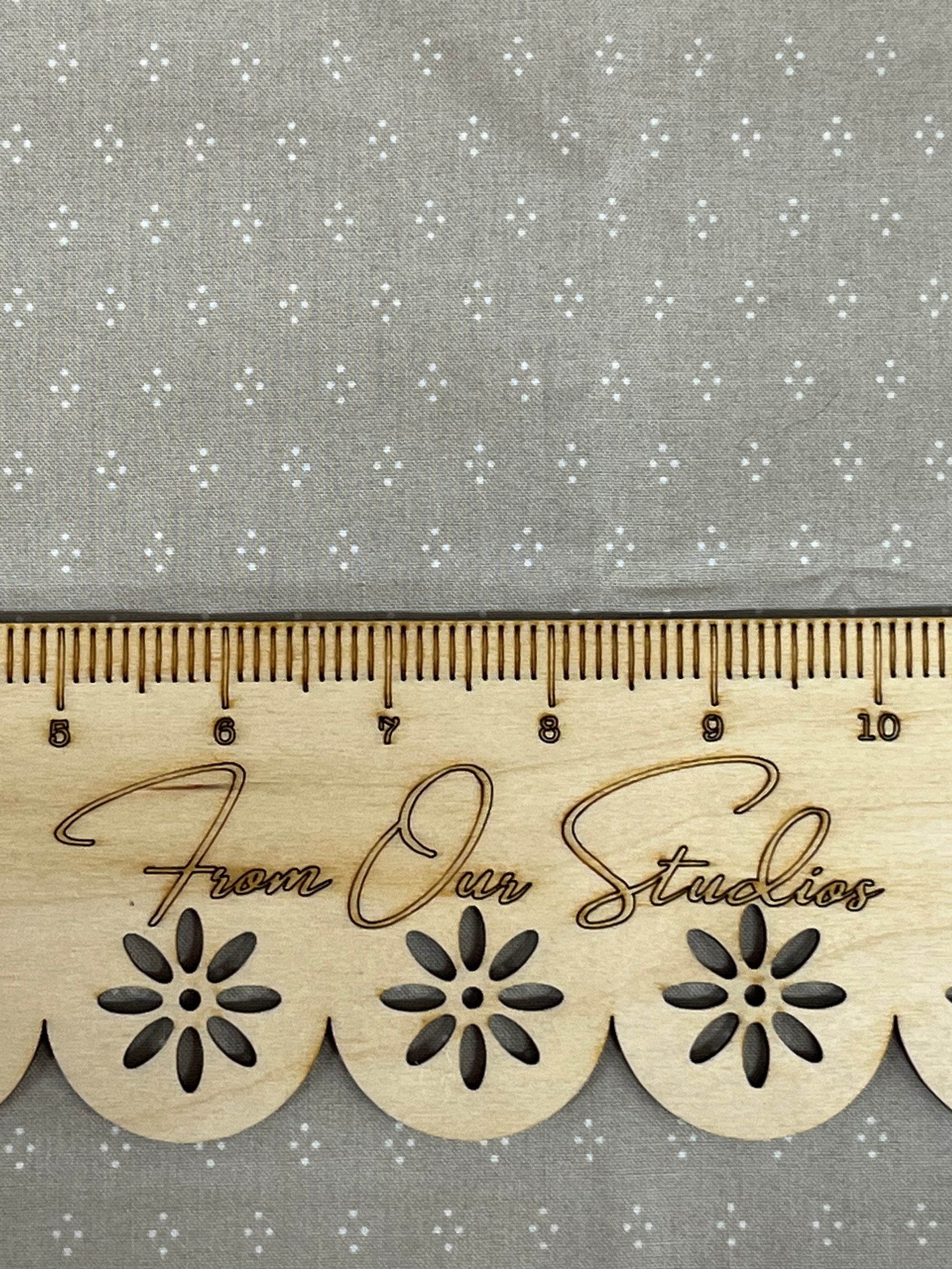 greige fabric with small white polka dots arranged in a diamond pattern great for quilt making slow stitching and junk journals