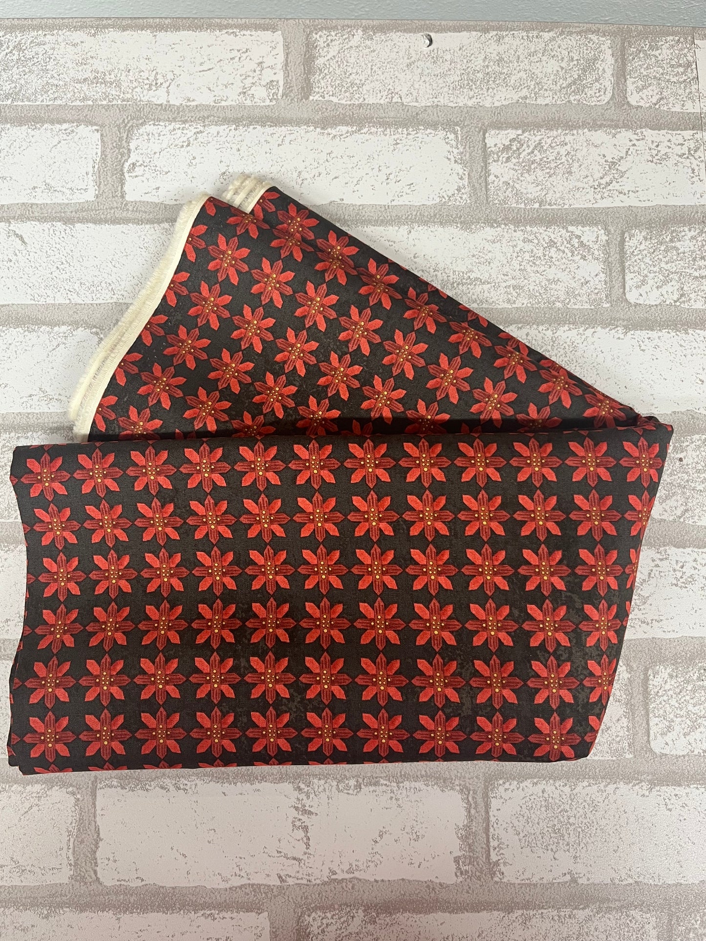 Festive poinsettia fabric fat quarter on black background, Kringle Collection by Riley Blake
