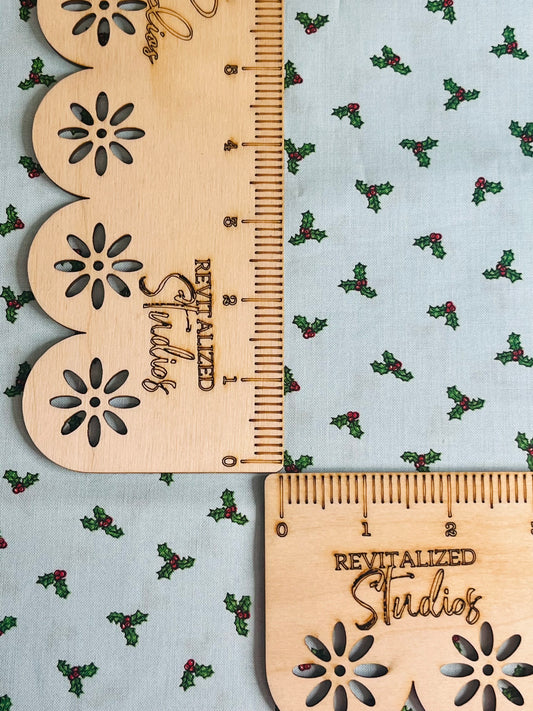 Blue quilting cotton by Riley Blake . Christmas themed with small holly leaves