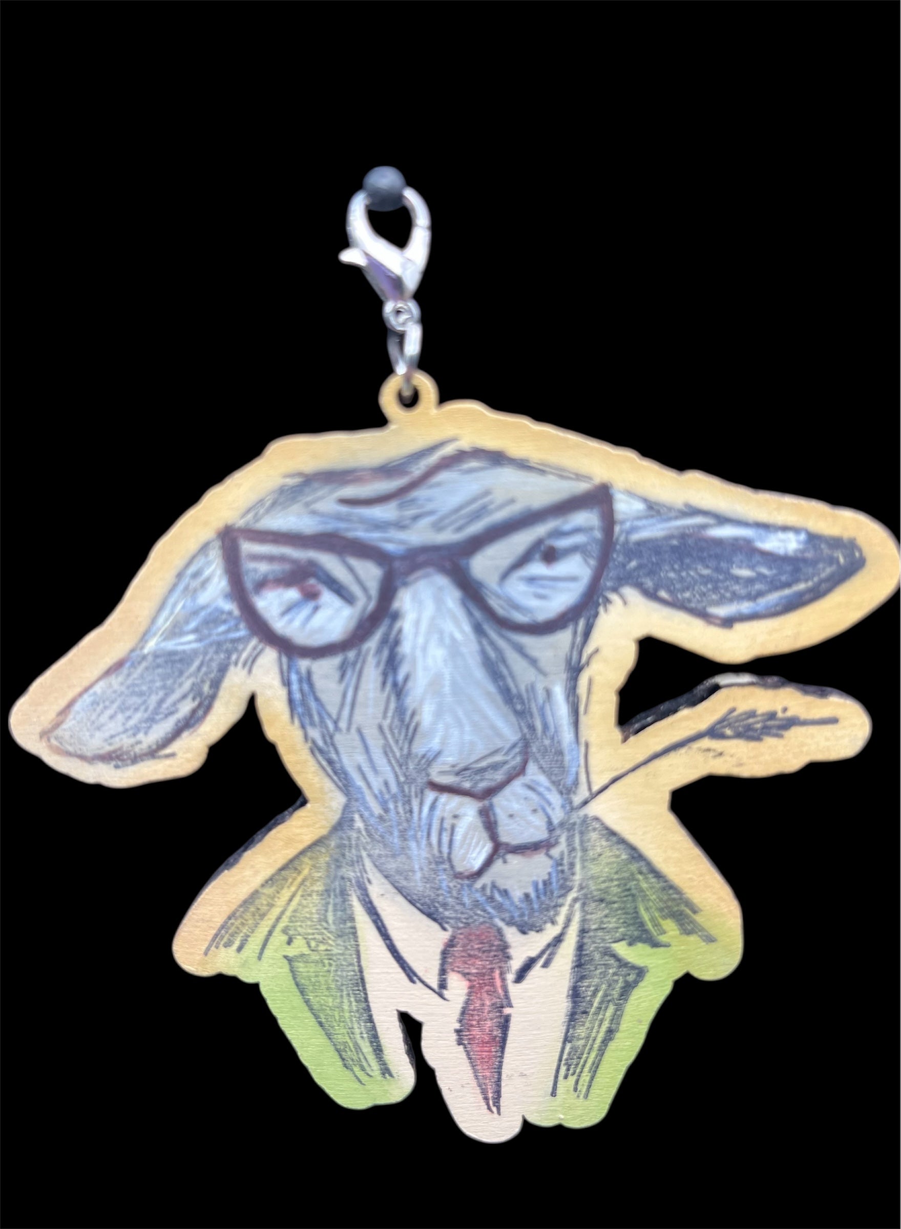 Hand-painted wooden goat charm wearing glasses, green jacket, and red tie with lobster clasp