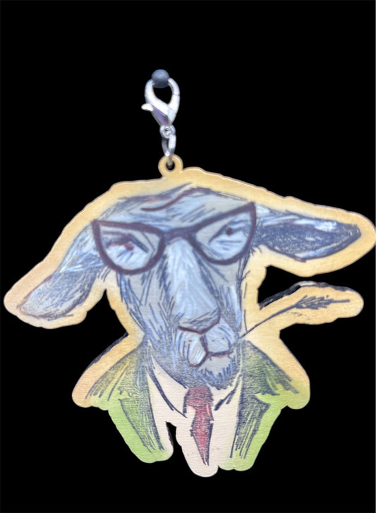 Hand-painted wooden goat charm wearing glasses, green jacket, and red tie with lobster clasp