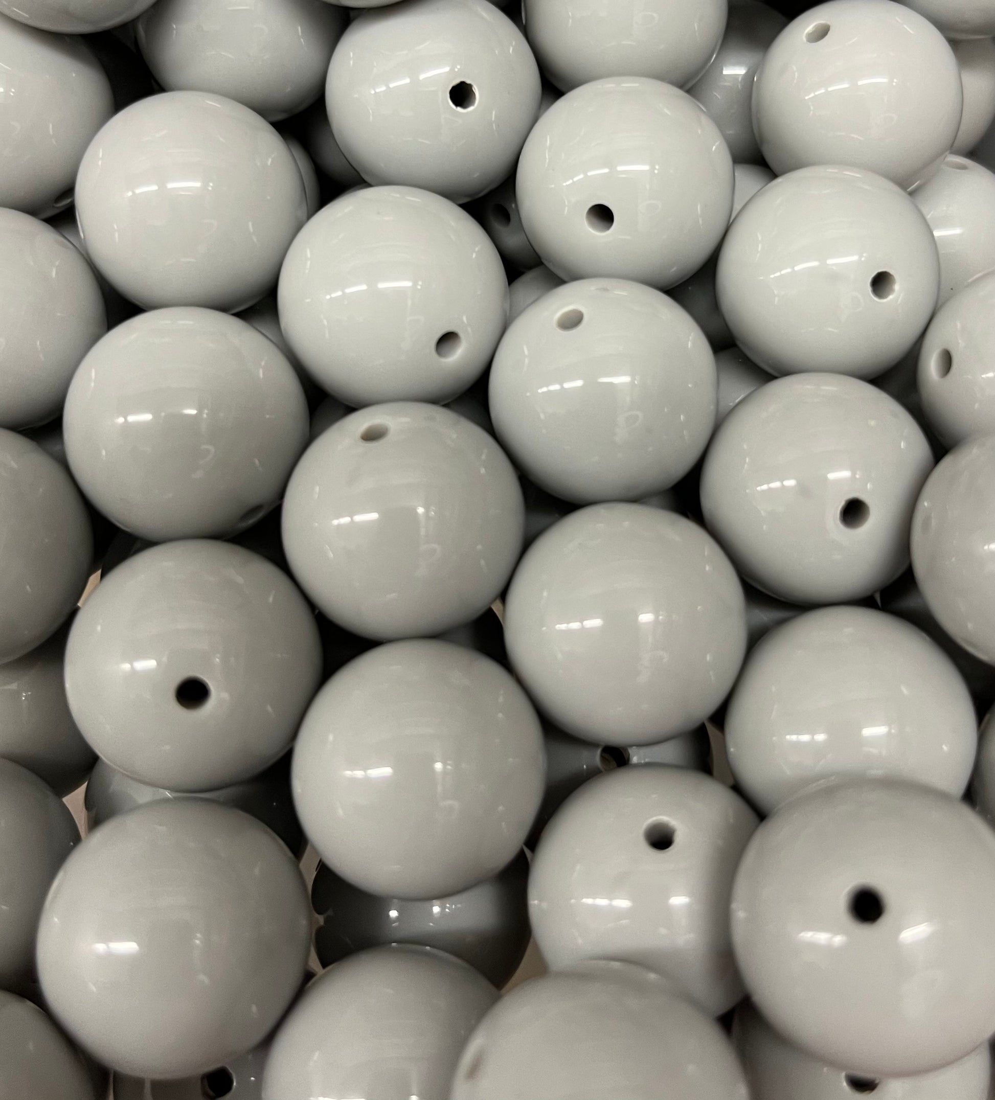 Glossy light gray 20mm bubblegum beads shown in a close-up view with color comparison to dark gray and blue gray beads.