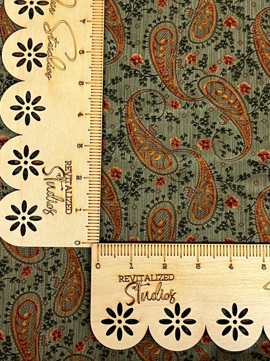 A fat quarter of green paisley fabric from Moda's Harvest Home Collection by Brannack and Patek, with a measuring tape marked '18 inches' and '21 inches'.
