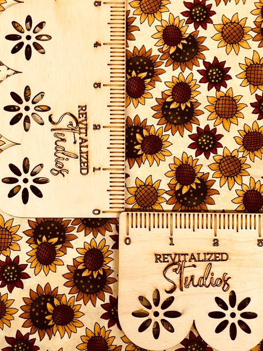 A fabric fat quarter featuring a kaleidoscope pattern with sunflowers design on a beige background, marked with the brand Moda and the text 'Revitalized Studios'.