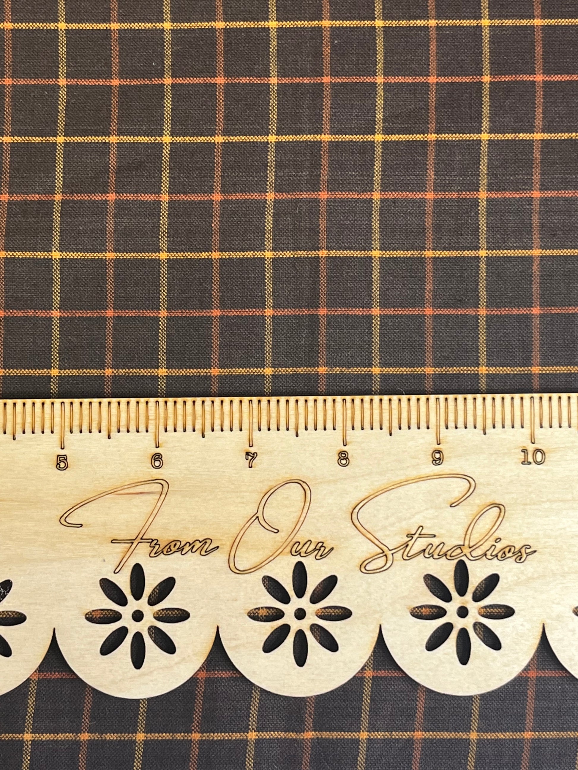 Medium-scale black plaid cotton fabric with rust and gold check pattern, 18x22 inch fat quarter by Andover Fabrics.