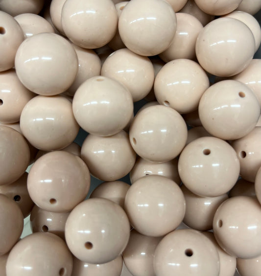 Close-up of glossy tan 20mm acrylic bubblegum beads for jewelry making and crafts