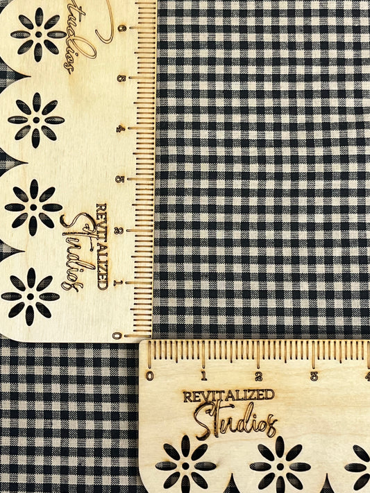 Close-up of tiny black and tan homespun check cotton fabric, ideal for quilting, primitive sewing, and doll making crafts.