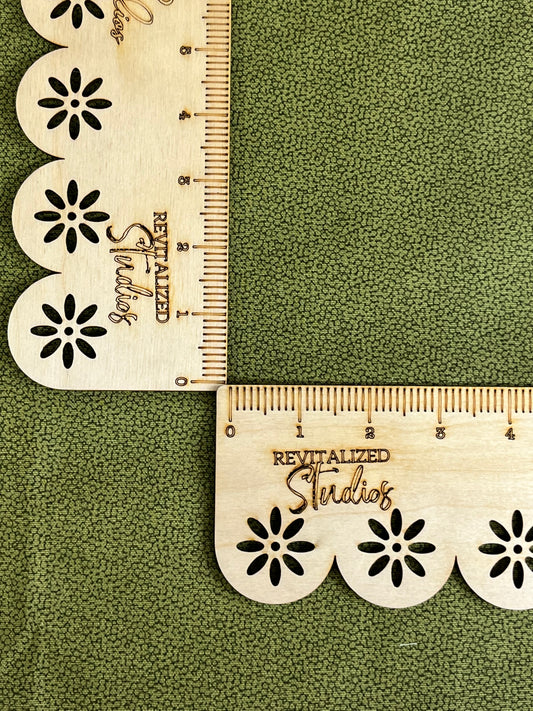 A fat quarter of fabric featuring a green background with a floral pattern design and a label that reads 'Waverly Inspirations Revitalized Studios'. The fabric is marked with a tape measure, indicating a scale of 2 1/2 inches in width.